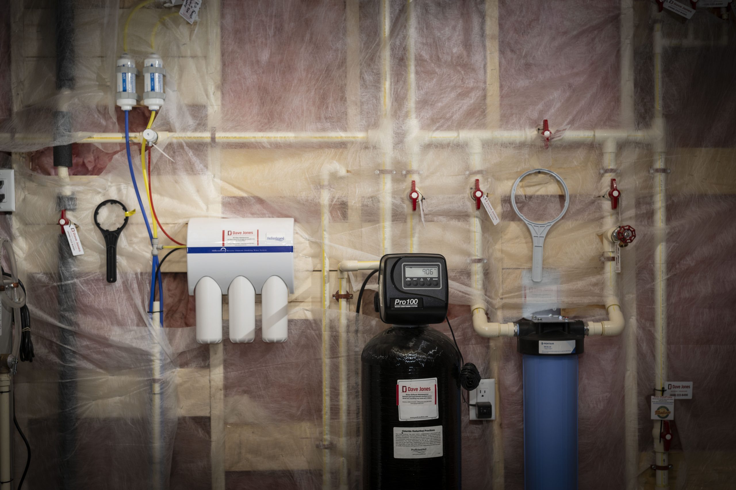 Picture of basement with water filtration system and water softener.