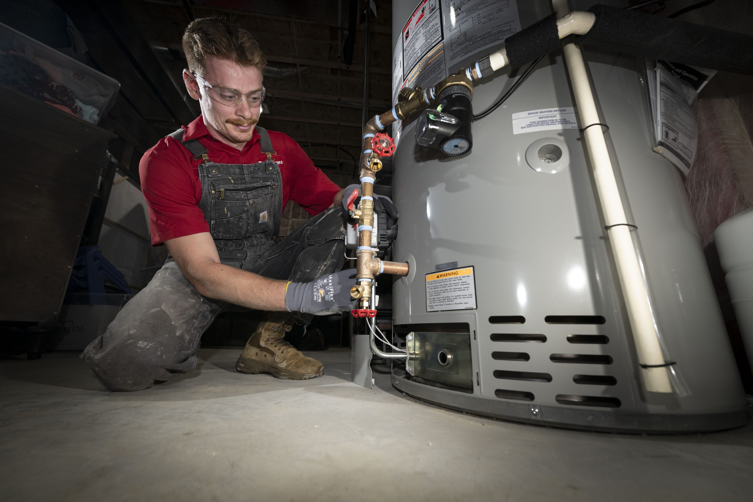 Dave Jones Plumber working on Traditional Tank Water Heater