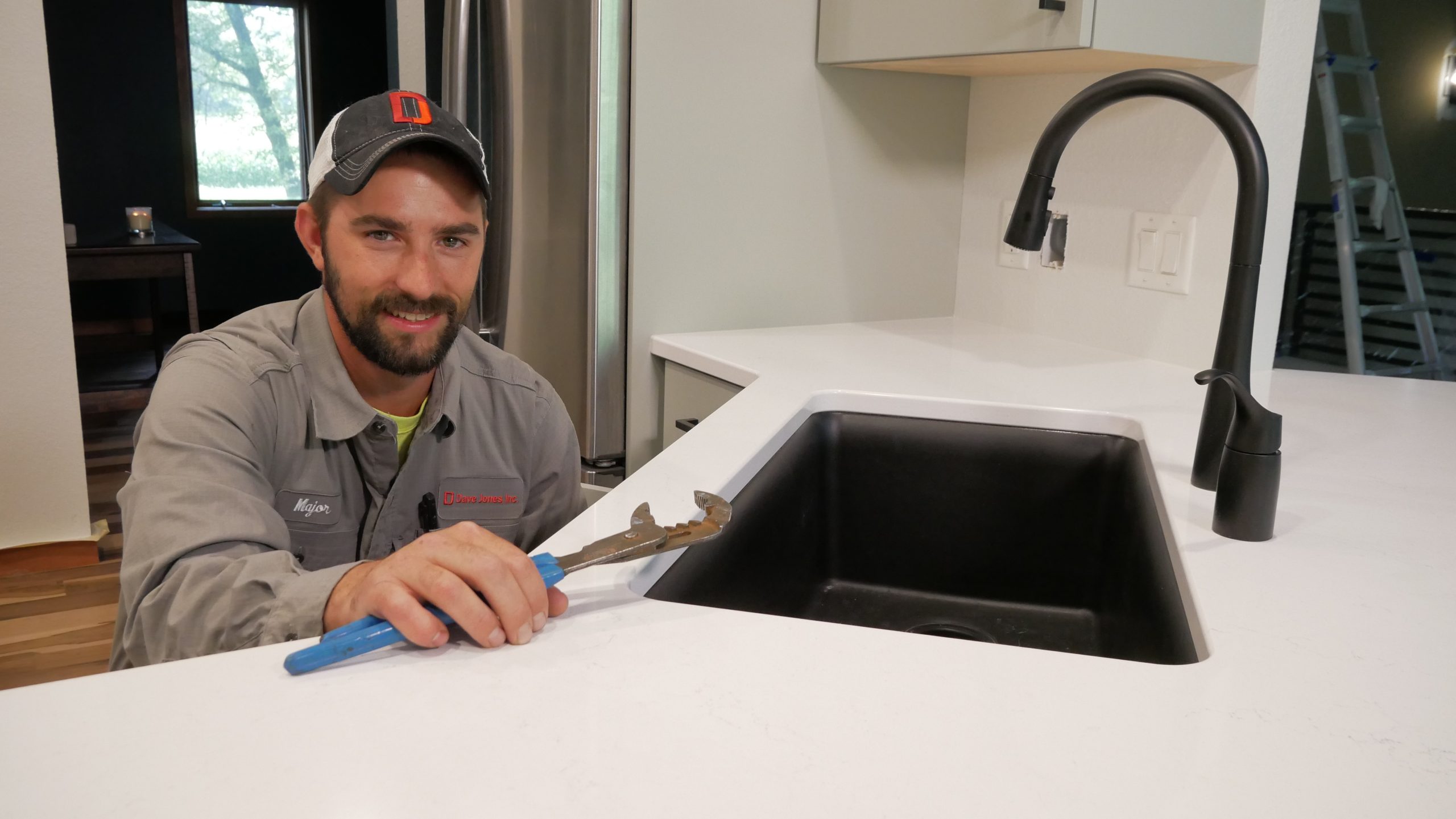 Plumber working under kitchen sink
