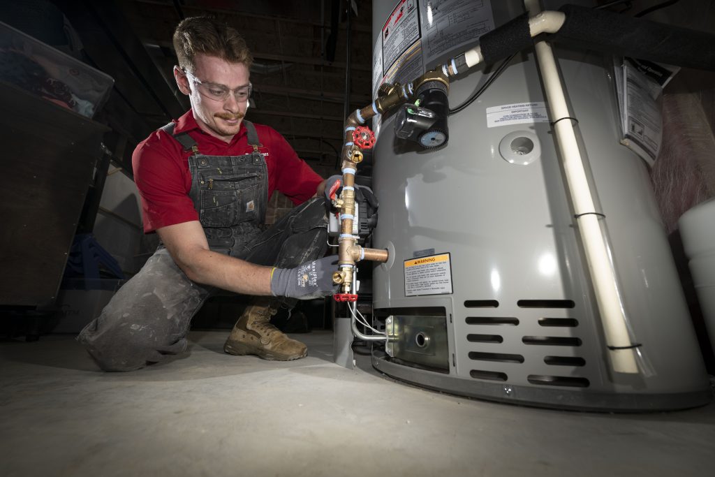 Dave Jones plumber working on water heater