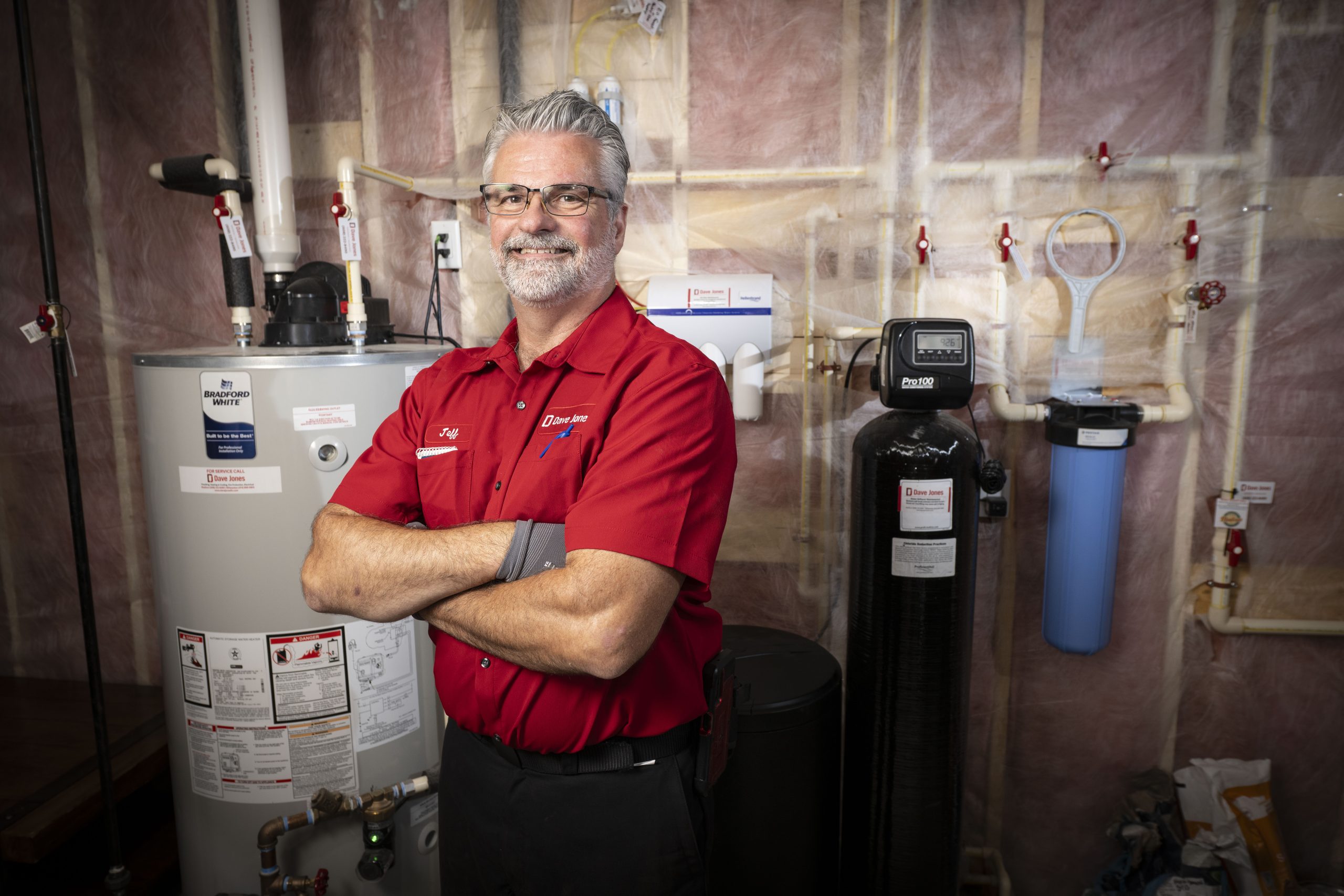 Madison Plumber in front of water heater and water softener