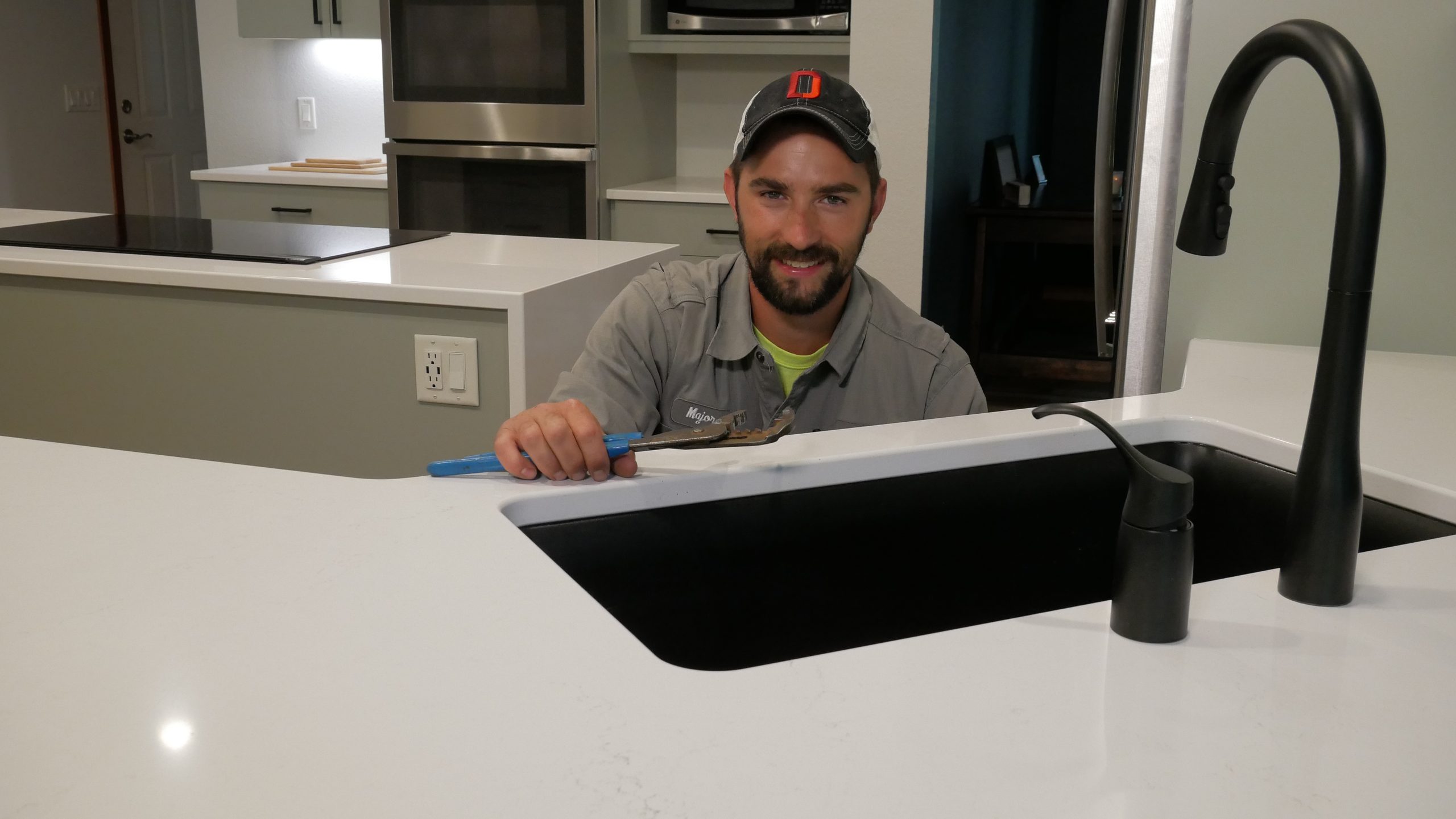 Dave Jones Plumber working at kitchen sink