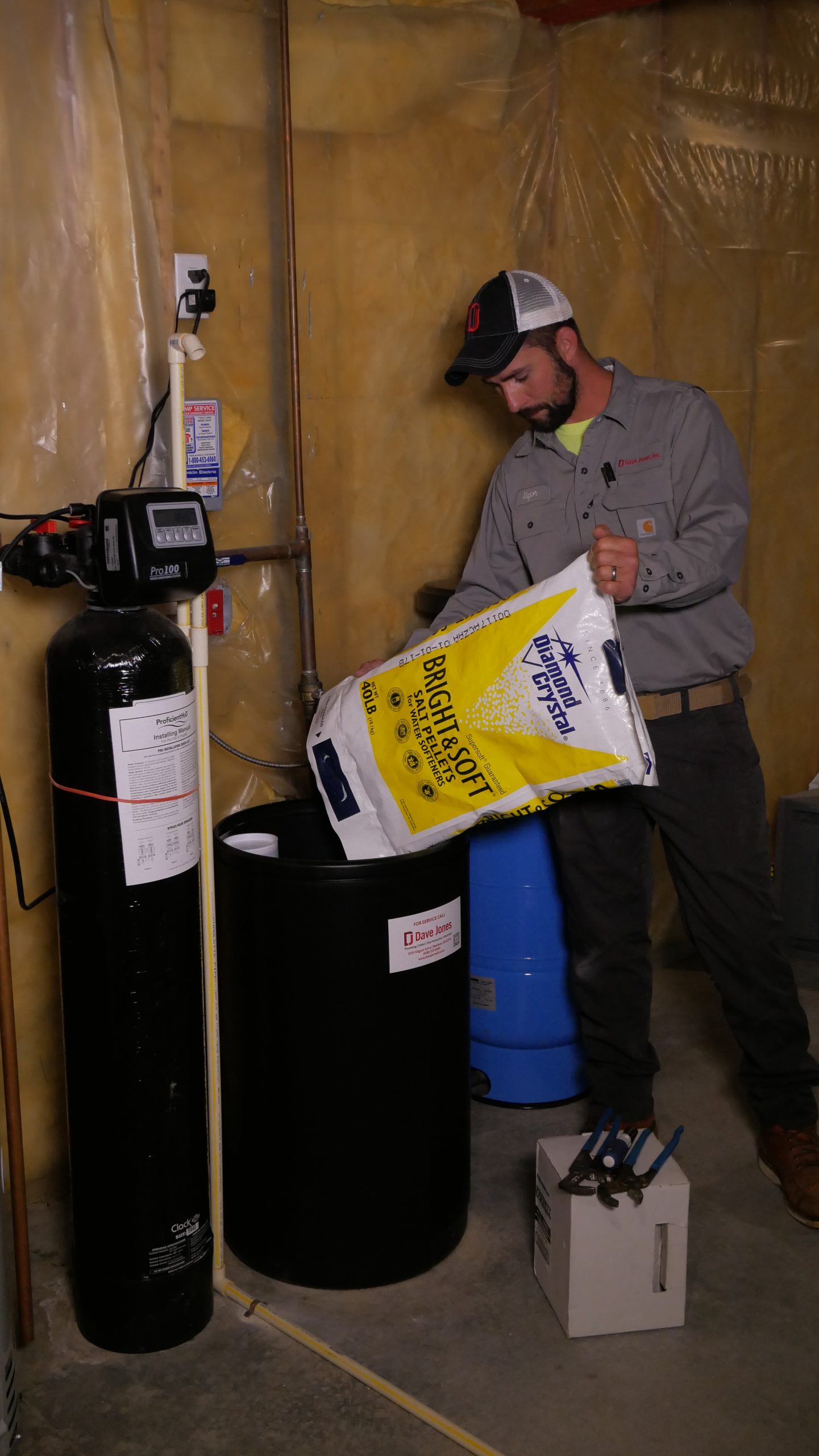 Dave Jones plumber adding salt to water softener