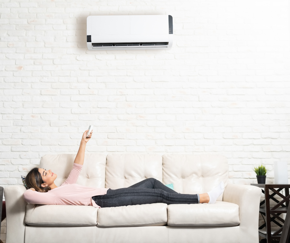 Women on couch in comfort of mini split HVAC system