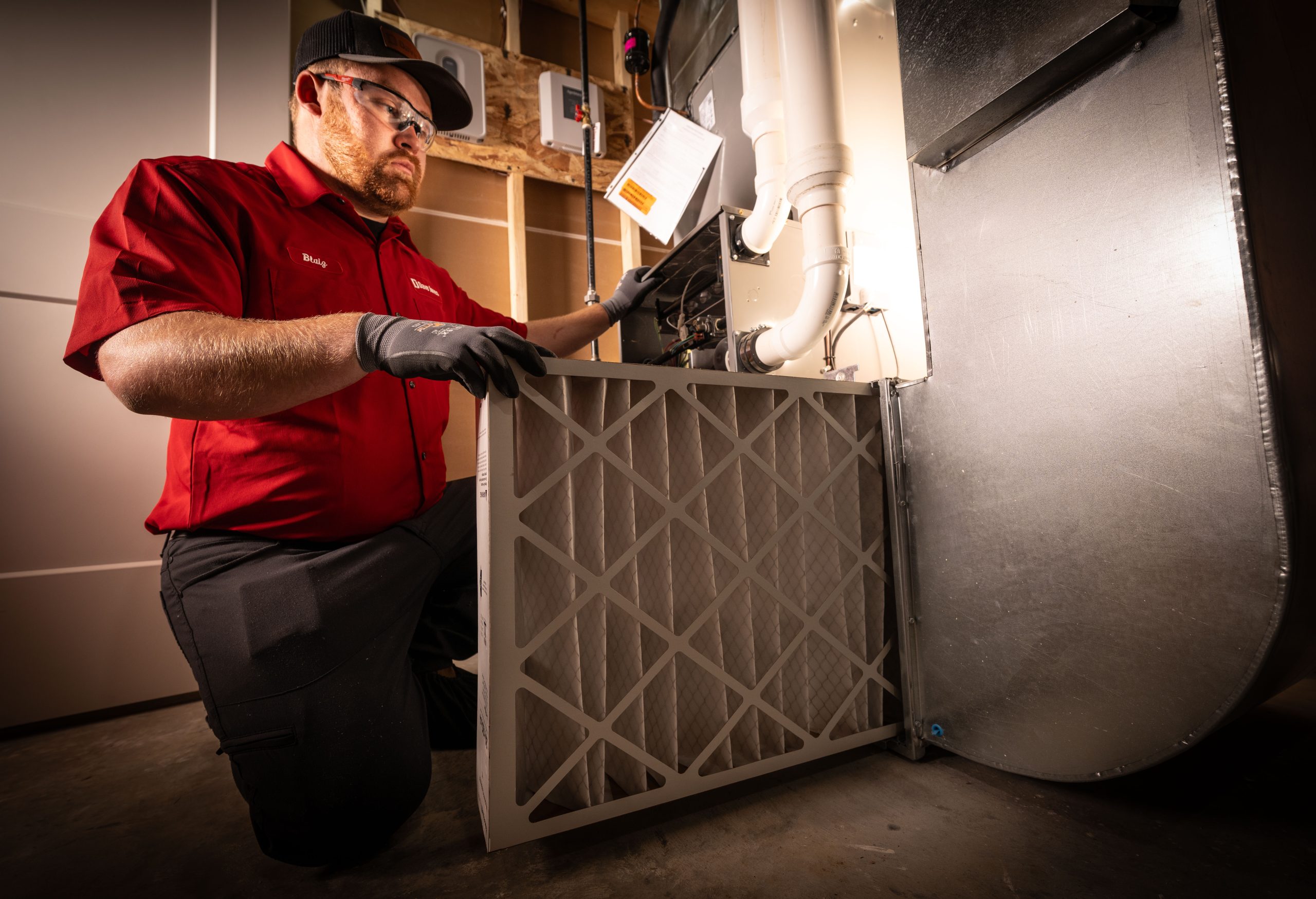 HVAC Technician changing furnace filtter