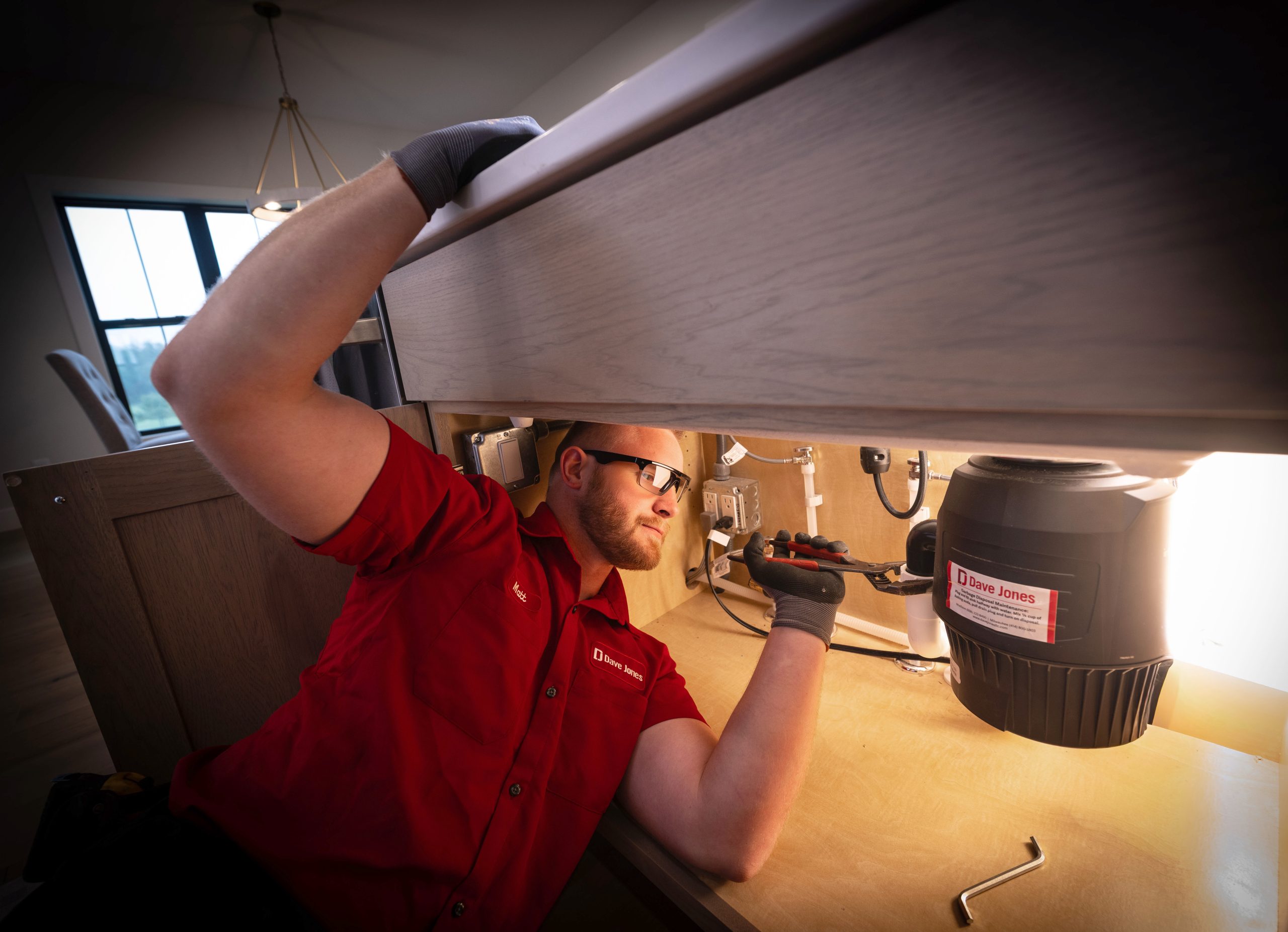dave jones plumber checking on a garbage disposal