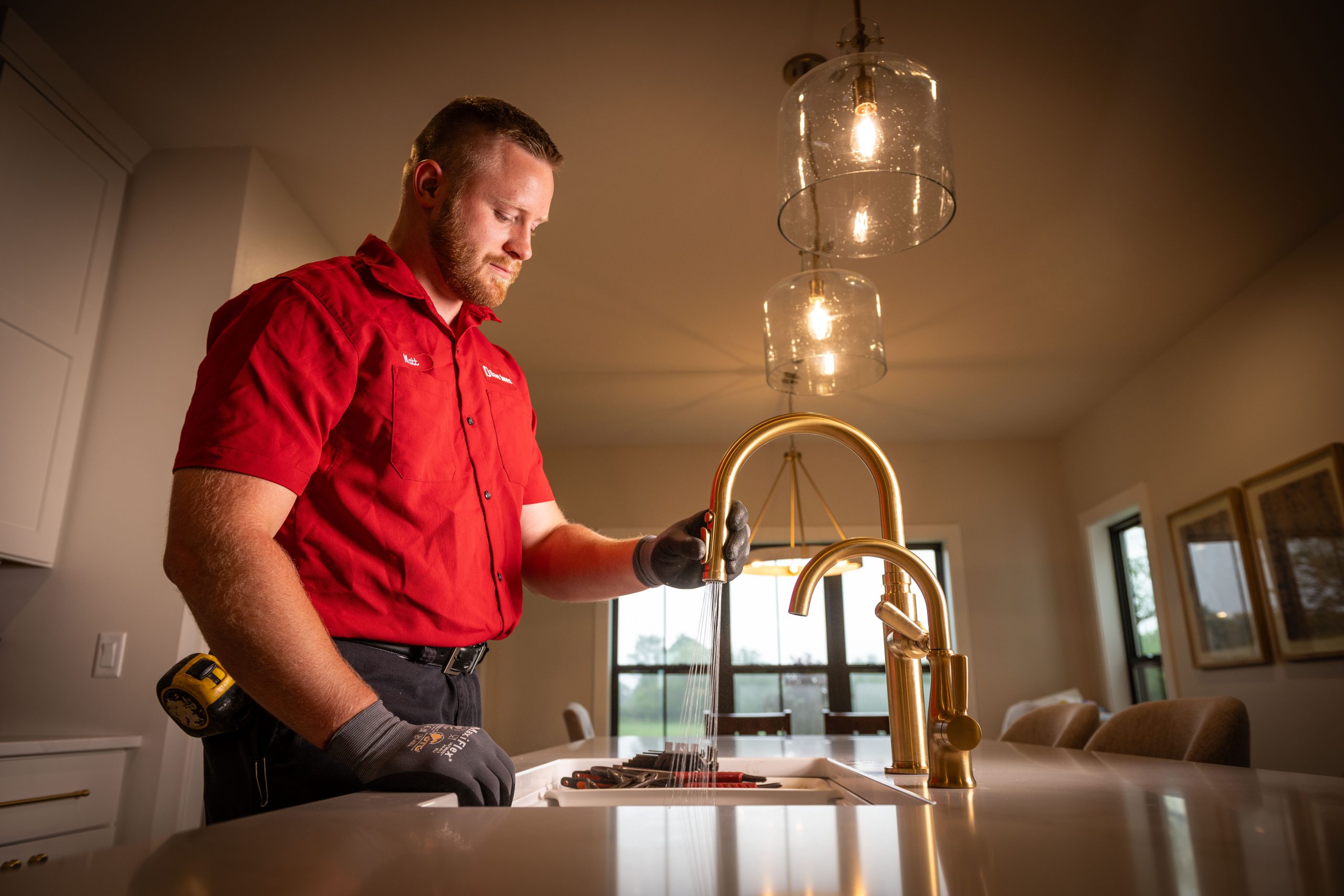 dave jones plumber testing kitchen faucet